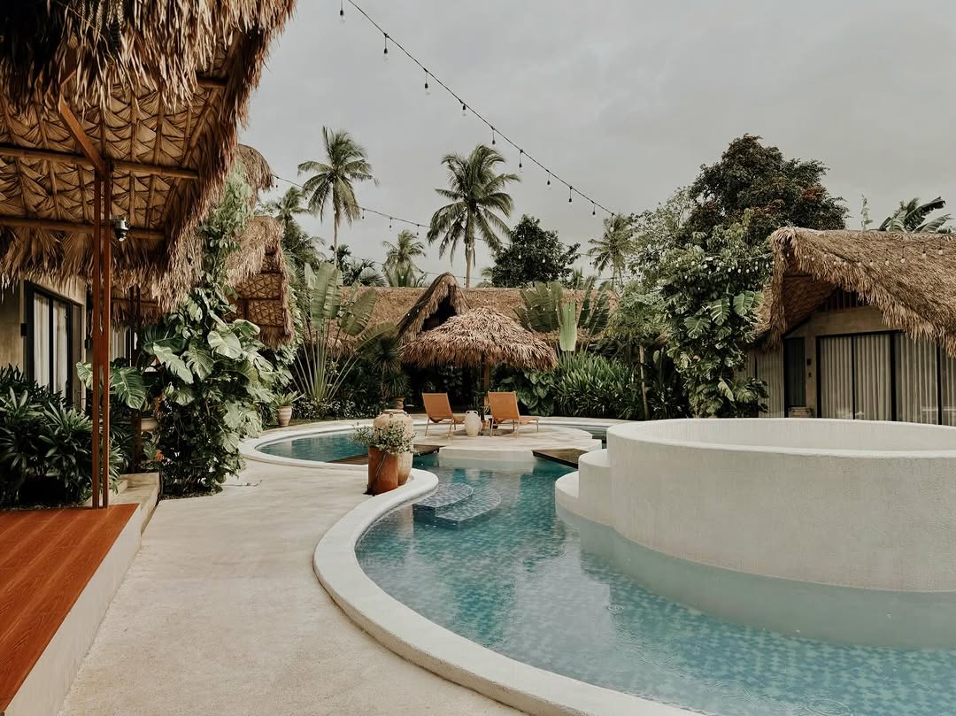 Beladi Villas compound with pool and thatched bungalows